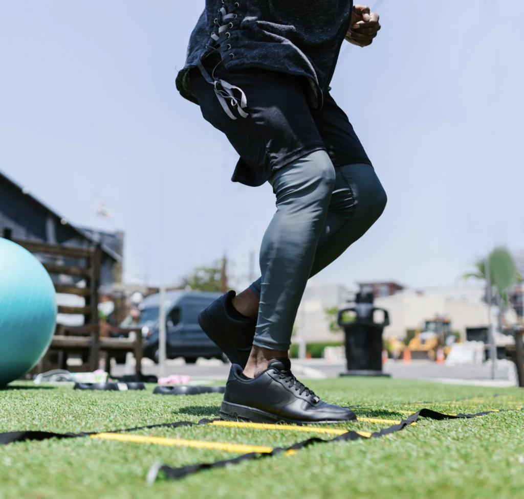 black man demonstrating agility ladder drills demonstraiting the need for balance, agility and stregth